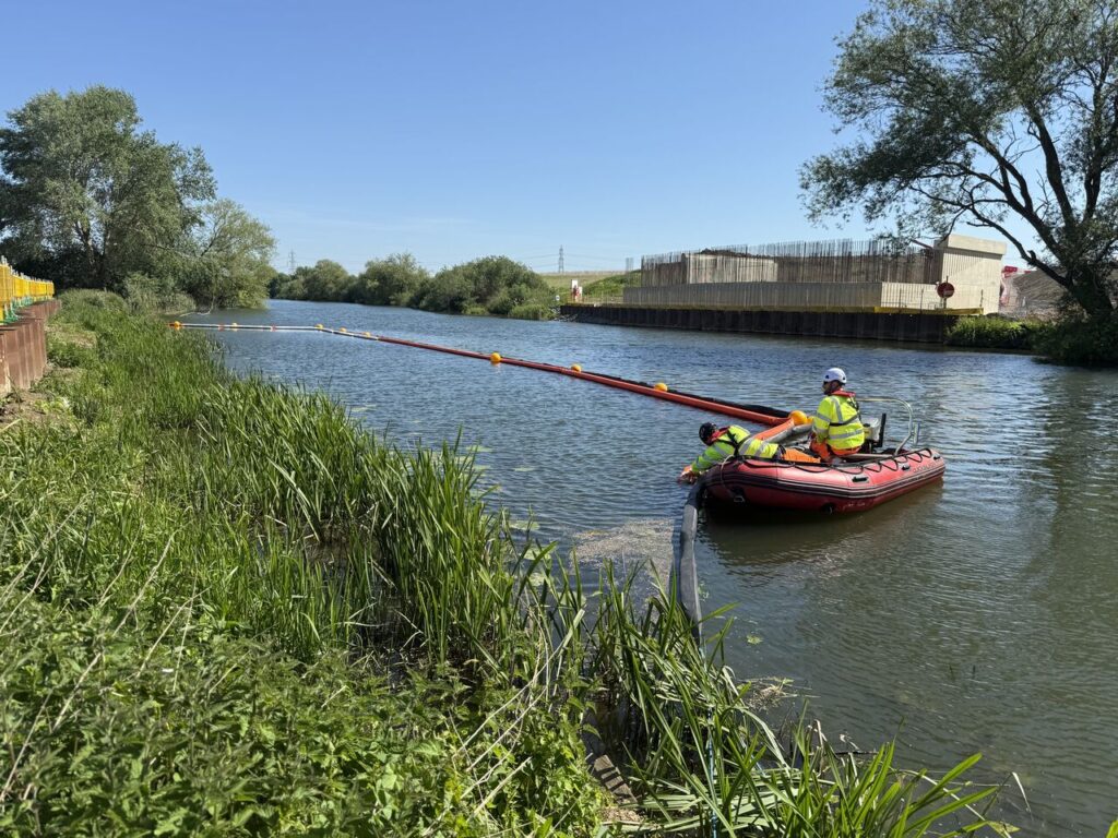 EPS workboat setting out a floating boom along the River Great Ouse