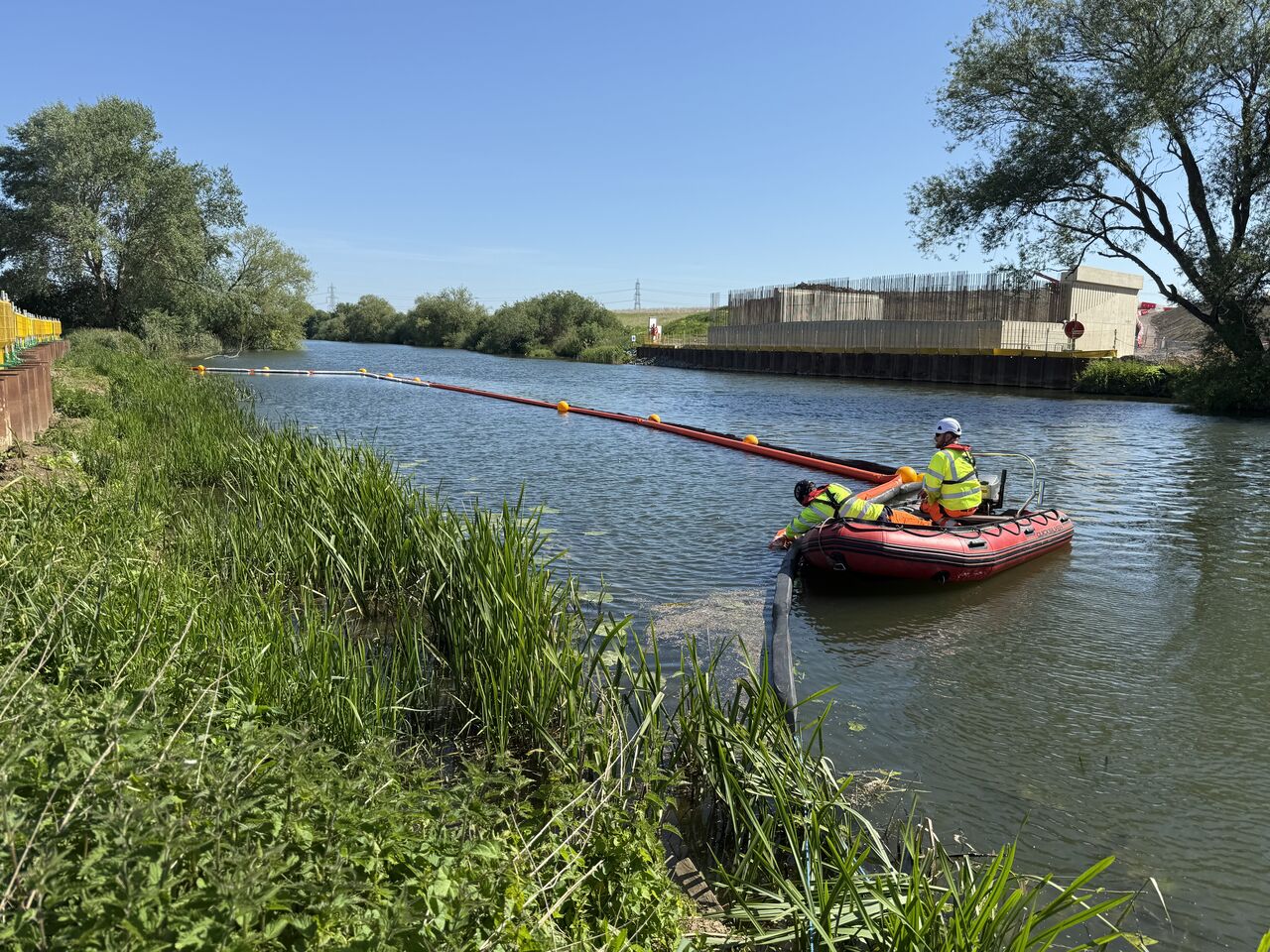 EPS workboat setting out a floating boom along the River Great Ouse